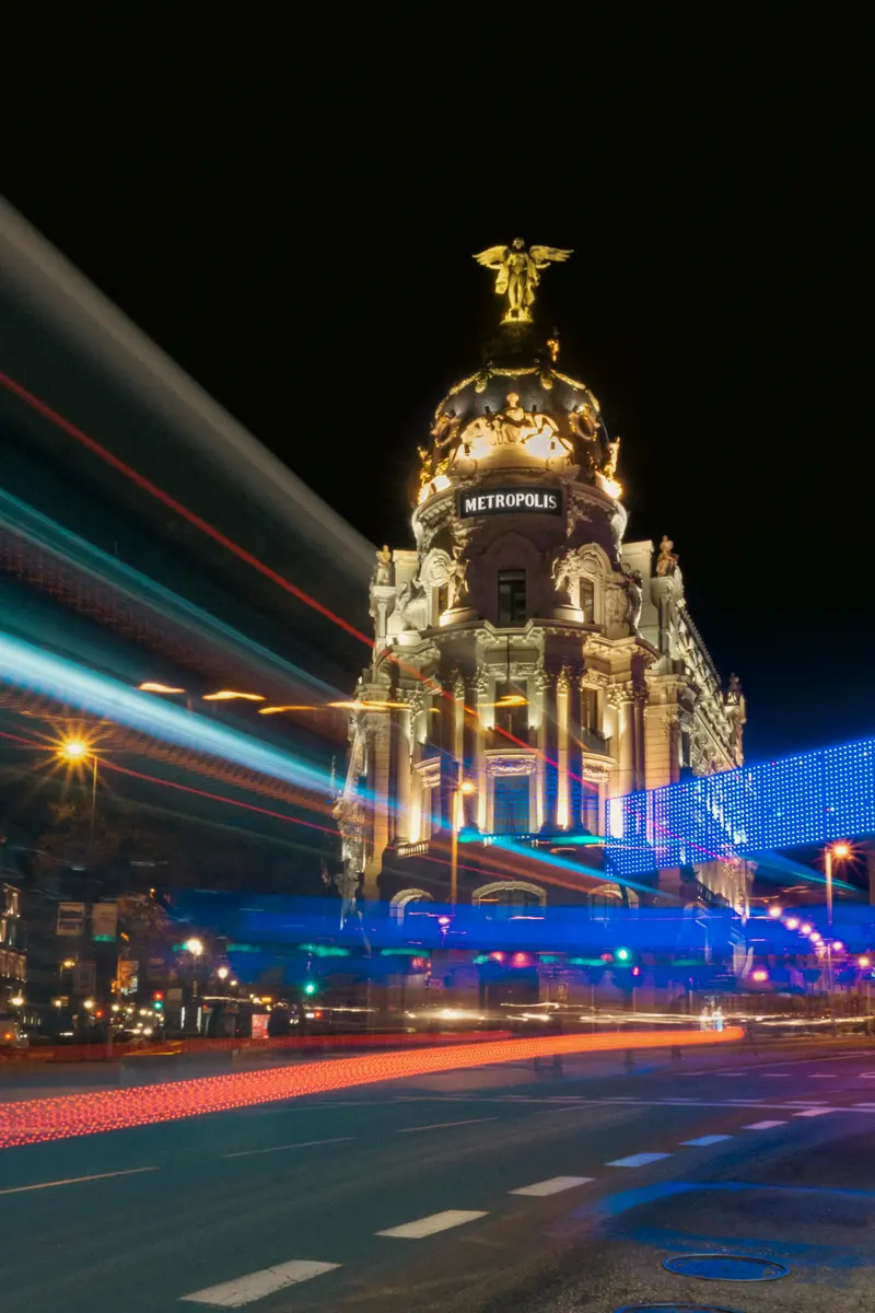 The Metrópolis building lit up at night, Madrid