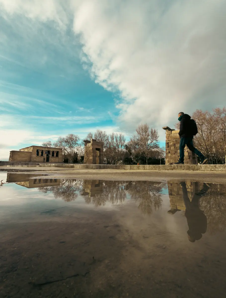 The Temple of Debod reflected in a puddle under a blue sky, Madrid